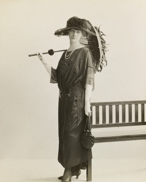 A photograph of Florence Mary Taylor. She is wearing a wide-brimmed hat and carries a parasol.