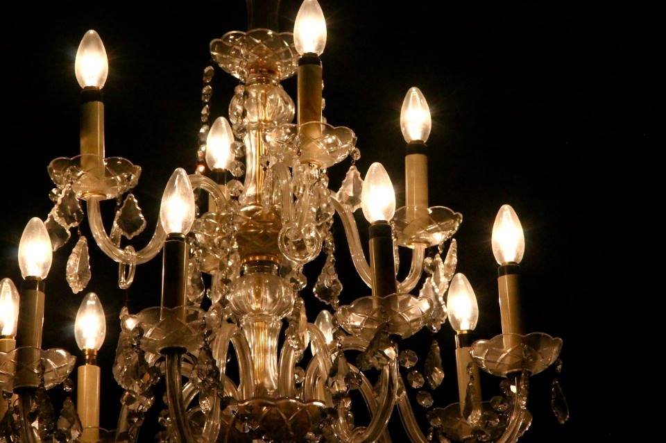 Crystal chandelier of History House. The chandelier gives off a warm light.