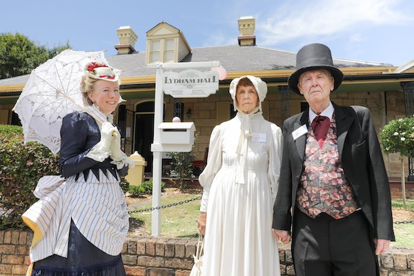 A photograph of Lydham Hall with people dressed in Victorian period clothing.