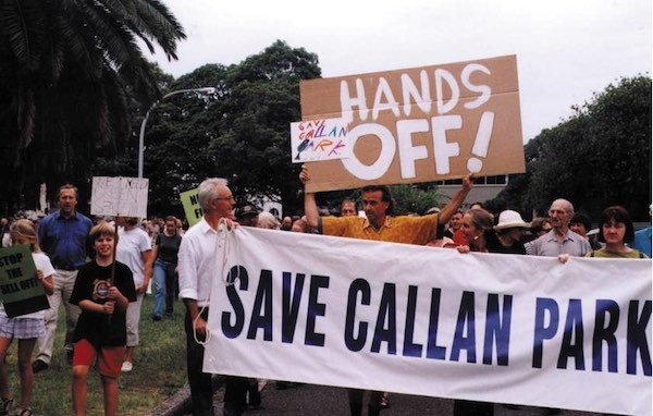 People marching and carrying signs that read 'Hands Off!' and 'Save Callan Park'